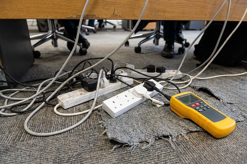 Testing extension leads under an office desk