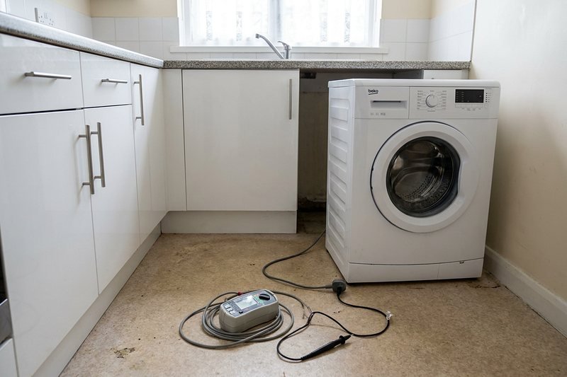 Testing a washing machine in a rental property kitchen