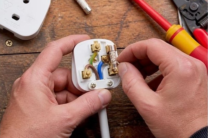 Fitting a new plug top and fuse to an appliance lead during a test visit